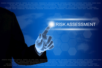 business hand clicking risk assessment button on touch screen